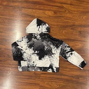 SHEIN Girls Splattered Paint Wrap Back Kangaroo Pocket Drop Shoulder Hoodie.